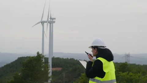 Woman engineer with tablet computer working with wind turbines Video stock 270454314