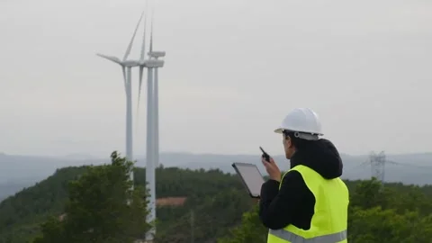 Woman engineer with tablet computer working with wind turbines Video stock 270454363
