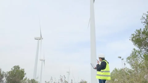 Woman engineer with tablet computer working with wind turbines Stock Footage 270455029