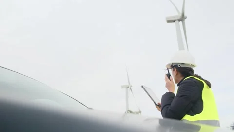 Woman engineer with tablet computer working with wind turbines Stock Footage 270455114