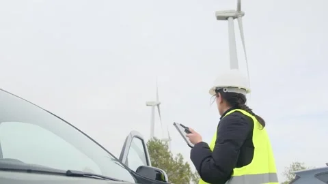 Woman engineer with tablet computer working with wind turbines Stock Footage 270455128