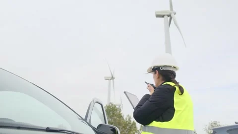 Woman engineer with tablet computer working with wind turbines Stock Footage 270455138