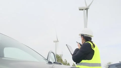 Woman engineer with tablet computer working with wind turbines Stock Footage 270455151