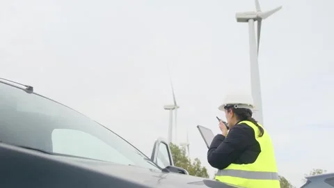 Woman engineer with tablet computer working with wind turbines Stock Footage 270455171