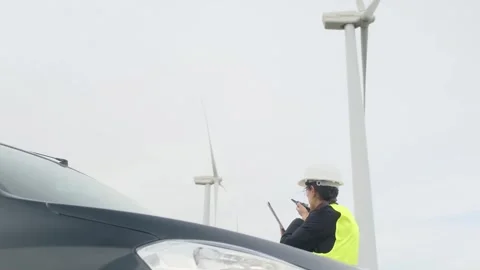 Woman engineer with tablet computer working with wind turbines Stock Footage 270455206