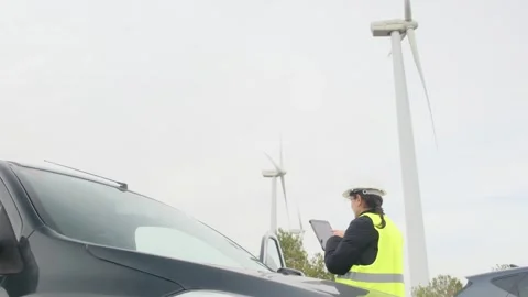 Woman engineer with tablet computer working with wind turbines Stock Footage 270455212