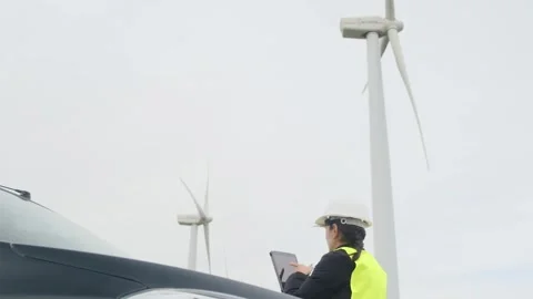 Woman engineer with tablet computer working with wind turbines Stock Footage 270455227