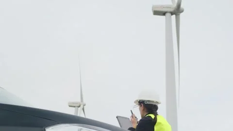 Woman engineer with tablet computer working with wind turbines Stock Footage 270455233
