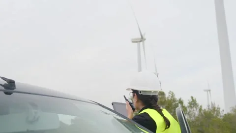 Woman engineer with tablet computer working with wind turbines Stock Footage 270455248