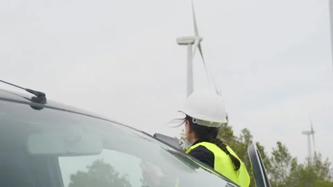 Woman engineer with tablet computer working with wind turbines Stock Footage 270455253