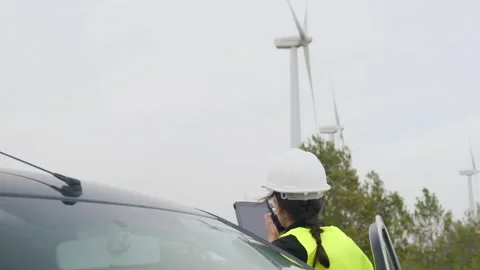 Woman engineer with tablet computer working with wind turbines Stock Footage 270455278