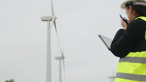 Woman engineer with tablet computer working with wind turbines Stock Footage 270455307