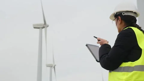 Woman engineer with tablet computer working with wind turbines Stock Footage 270455338