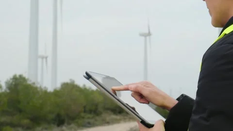 Woman engineer with tablet computer working with wind turbines Stock Footage 270455382