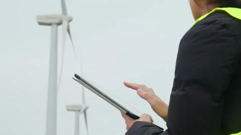 Woman engineer with tablet computer working with wind turbines Stock Footage 270455391