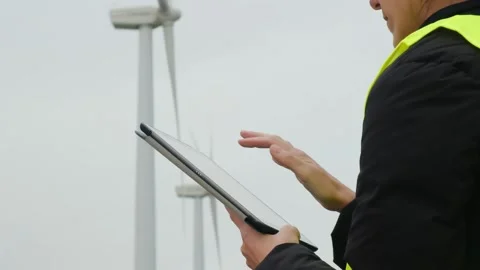 Woman engineer with tablet computer working with wind turbines Stock Footage 270455420