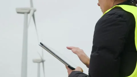 Woman engineer with tablet computer working with wind turbines Stock Footage 270455444
