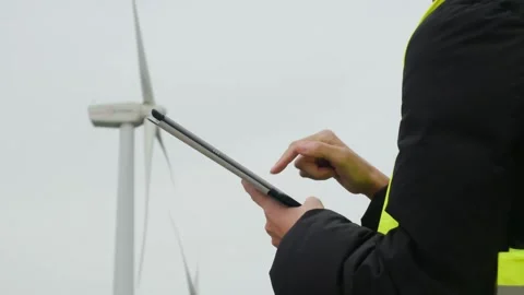 Woman engineer with tablet computer working with wind turbines Stock Footage 270455473