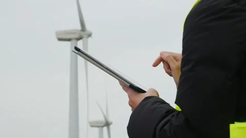 Woman engineer with tablet computer working with wind turbines Stock Footage 270455481