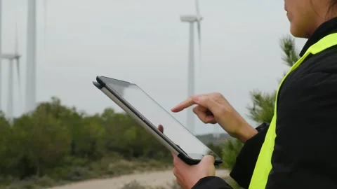 Woman engineer with tablet computer working with wind turbines Stock Footage 270455513
