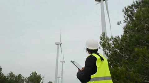 Woman engineer with tablet computer working with wind turbines Stock Footage 270455528