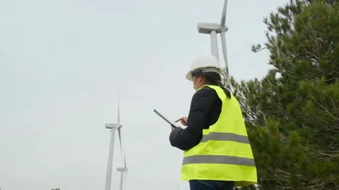 Woman engineer with tablet computer working with wind turbines Stock Footage 270455547