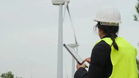 Woman engineer with tablet computer working with wind turbines Stock Footage 270455573