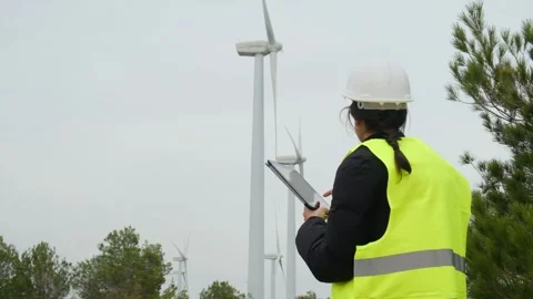 Woman engineer with tablet computer working with wind turbines Stock Footage 270455615