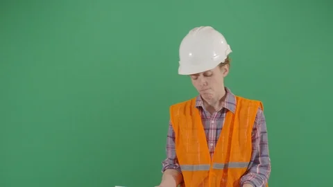 Woman engineer using a level on green screen studio isolated shot against green Stock Footage 119804461