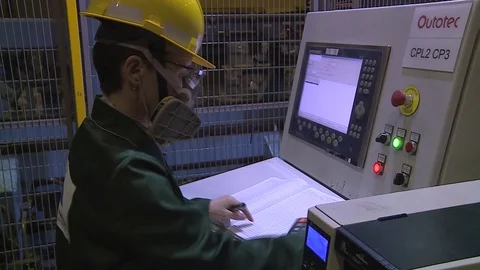 Woman engineer working with computer in hardhat and mask at a industry factory. Stock Footage 75993011