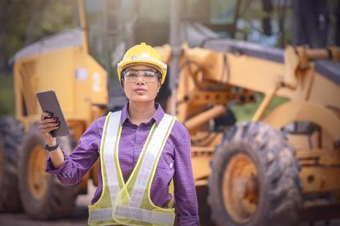Woman engineers construction worker checking layout on digital ipad . Foreman Stock Photos