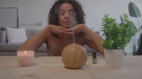 Woman Enjoying an Aromatherapy Diffuser at Home During the Daytime Stock Footage 208801870