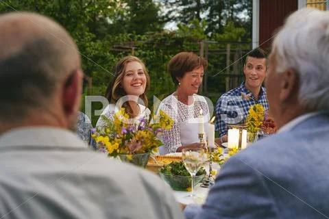 Woman enjoying family garden party dinner Stock Photos