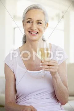 Woman Enjoying A Glass Of White Wine Stock Photos
