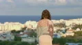 Woman enjoying sea breeze on hill, looking at seaside town. Feeling of freedom HD Footage