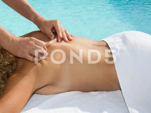 Woman enjoying shoulder massage at beauty spa Stock Photos