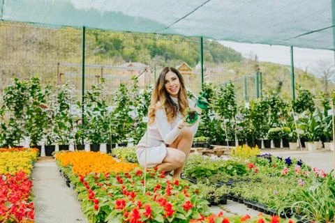 Woman enjoys planting flowers Stock Photos