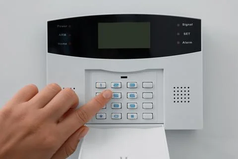 Woman entering code on home security system indoors, closeup Stock Photos