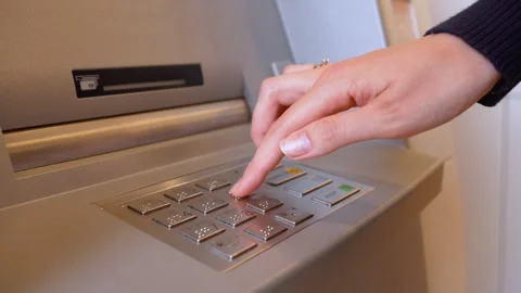 Woman entering pin code on atm keypad 動画素材 337884379