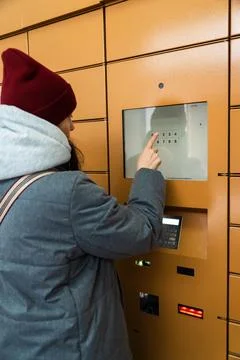 Woman entering security code in underground parking lot at city center Stock Photos