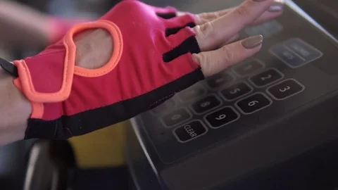 Woman enters a training program on the treadmill. female hands closeup Stock Footage 81527089