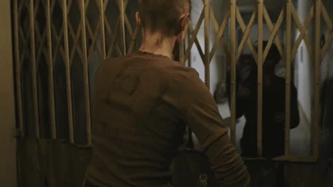 Woman Escaping Zombies behind Elevator Gate Stock Footage 195983501