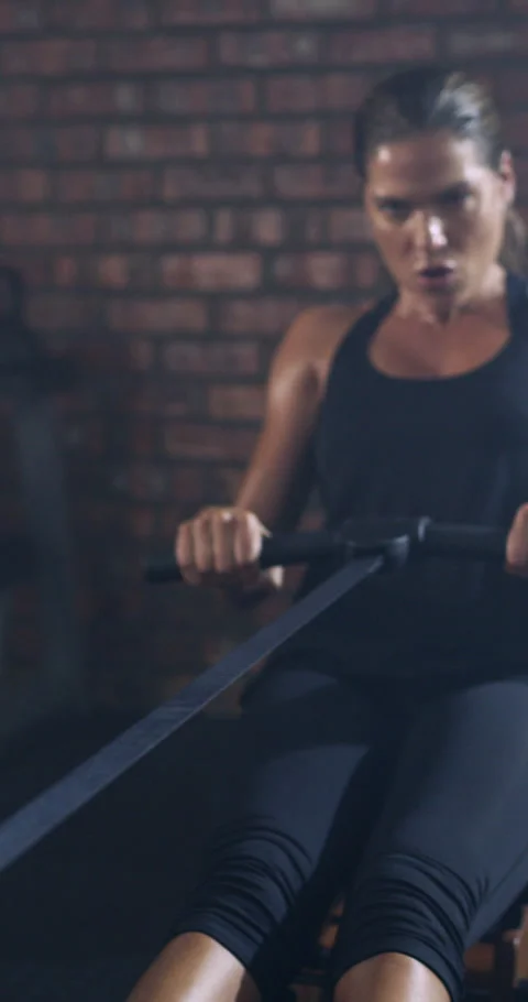 Woman, exercise and rowing machine in gym with fitness, endurance and strength Stock Footage 329832366