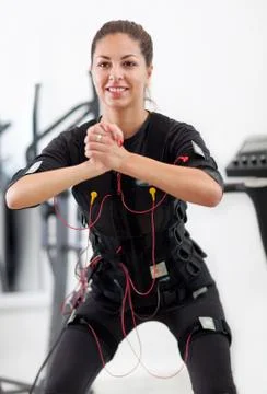 Woman exercise key position  on  electro stimulation machine Stock Photos