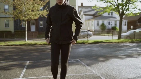 Woman exercising, doing jumping exercise on sunny playground. Slow Motion Stock Footage 109732521