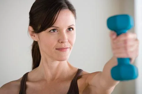 Woman exercising with dumbbell Stock Photos