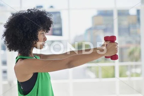Woman exercising with dumbbells Stock Photos