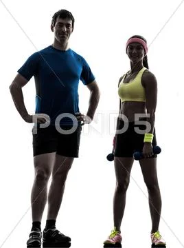 Woman exercising fitness workout with man coach posing silhouette Stock Photos