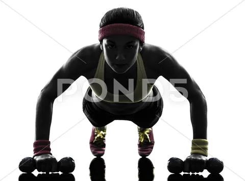 Woman exercising fitness workout push ups silhouette Stock Photos