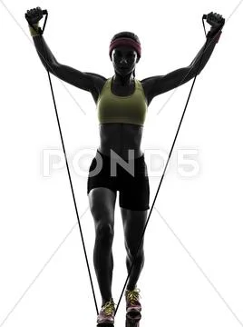 Woman exercising fitness workout resistance bands silhouette Stock Photos